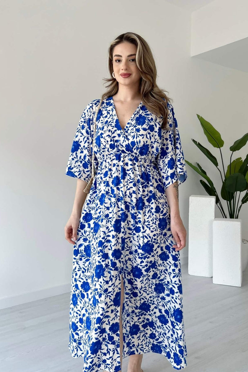 Lady wearing blue floral calf length rayon dress