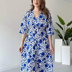 Lady wearing blue floral calf length rayon dress