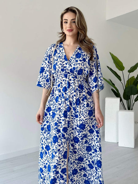 Lady wearing blue floral calf length rayon dress