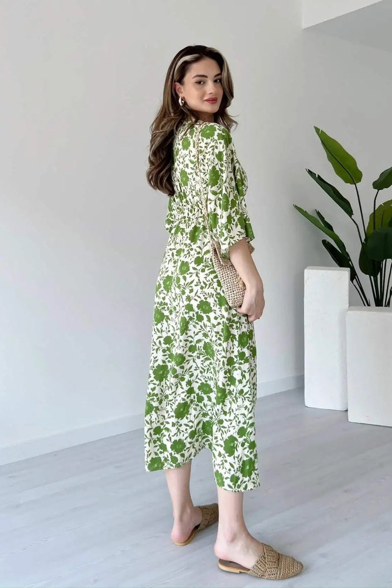 Girl wearing green printed calf length rayon dress