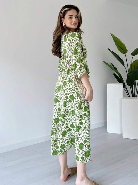 Girl wearing green printed calf length rayon dress