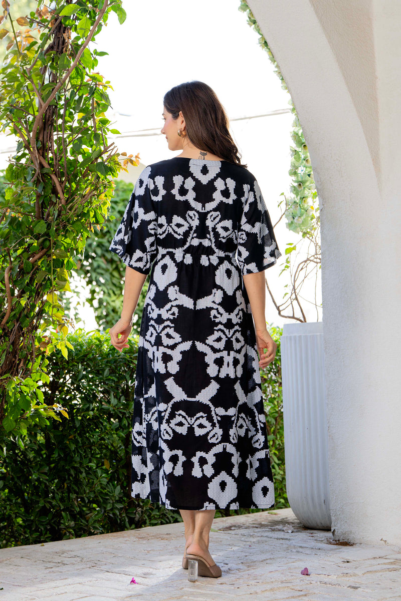 Women wearing black printed calf length dress
