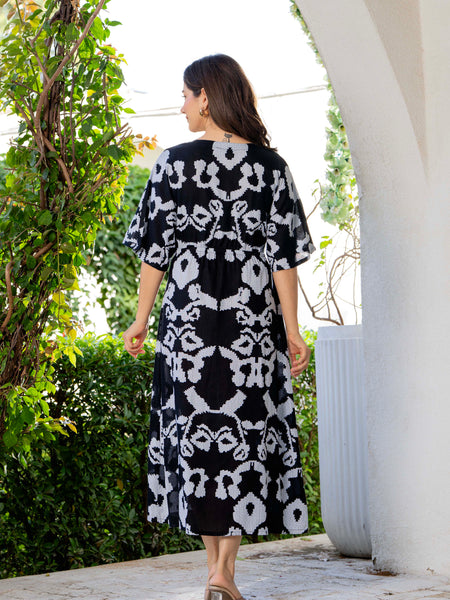 Women wearing black printed calf length dress
