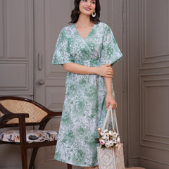 Lady wearing green fit and flare floral dress
