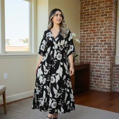 Girl black printed rayon dress walking pose
