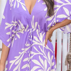 Lady wearing purple calf length rayon dress

