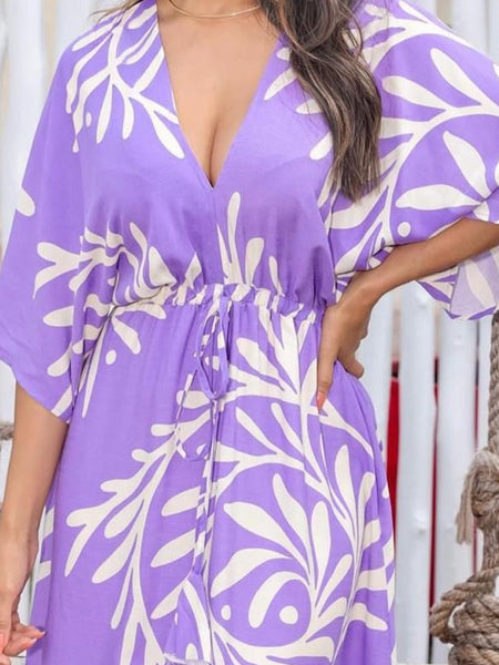 Lady wearing purple calf length rayon dress
